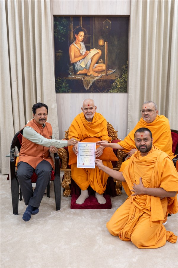 Prof. Niranjanbhai Patel, Vice Chancellor, Sardar Patel University, Gujarat, presents a PhD certificate to Viveknishth Swami