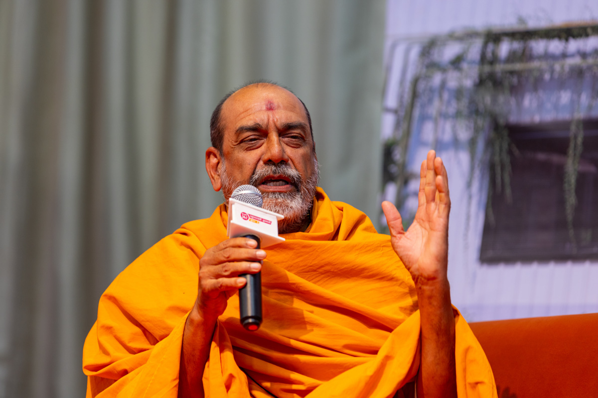 A swami participates in a discussion session