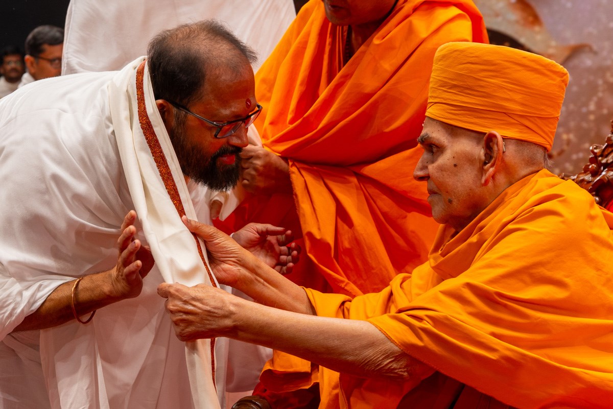 Swamishri honors Pujya Gurudevshri Rakeshji with a shawl