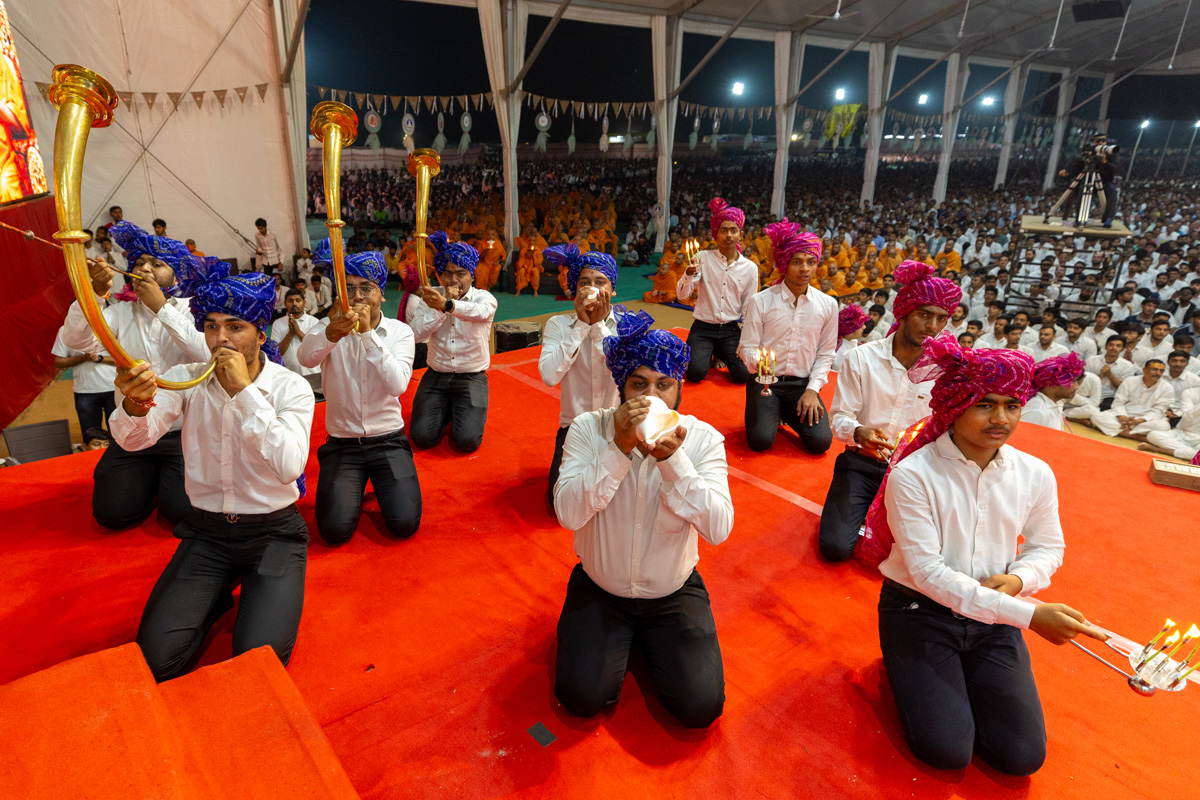 Youths perform the arti