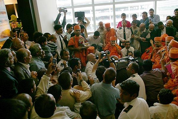  Swamishri seated amongst devotees at Terminal 3 listening to Viveksagar Swami