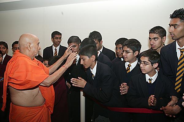  Swamishri blessing students from The Swaminarayan School