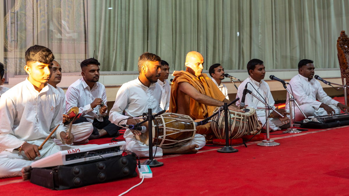 Youths sing kirtans in the evening assembly