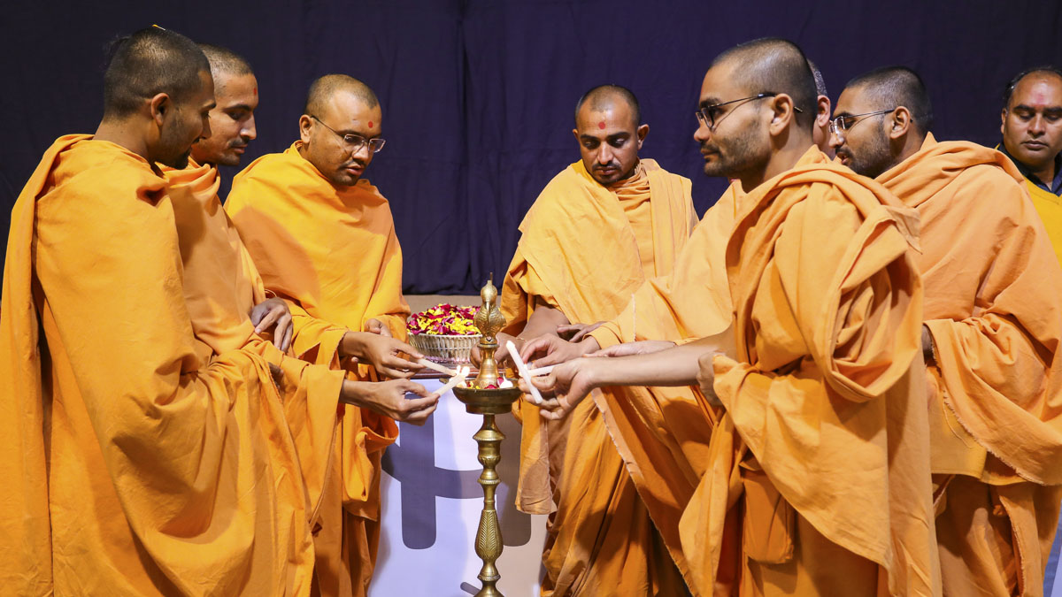 Sadhus who look after children’s activities light sacred lamps to inaugurate the convention