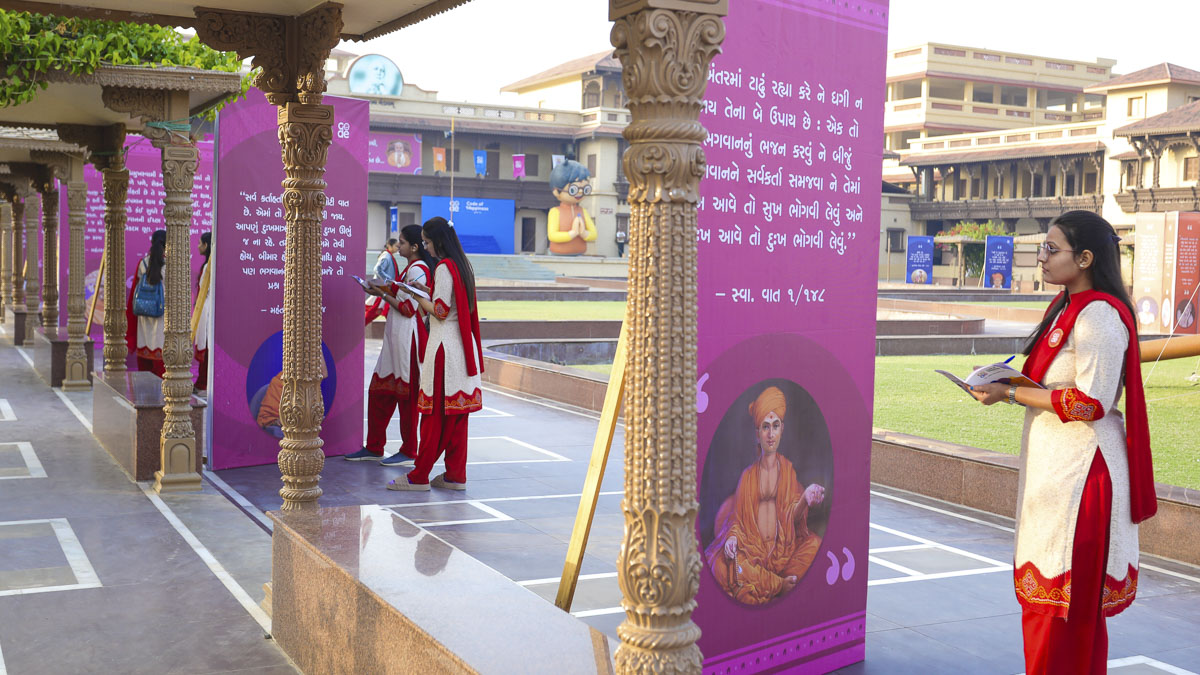 Balika karyakars make notes in their codebooks