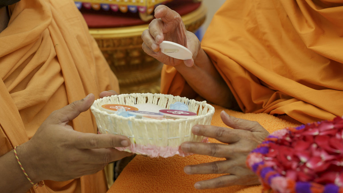 Swamishri sanctifies the delegate badge