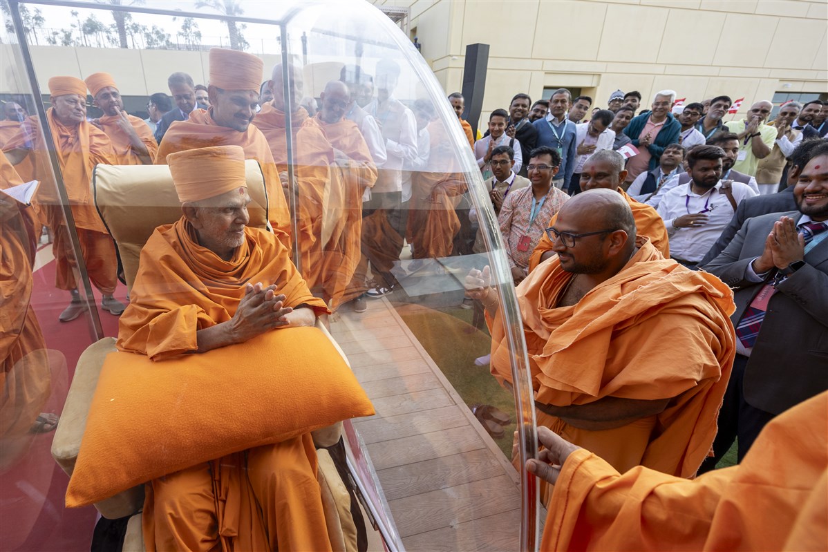 Swamishri blesses a swami who has been involved in the construction of the Mandir and campus buildings since their inception