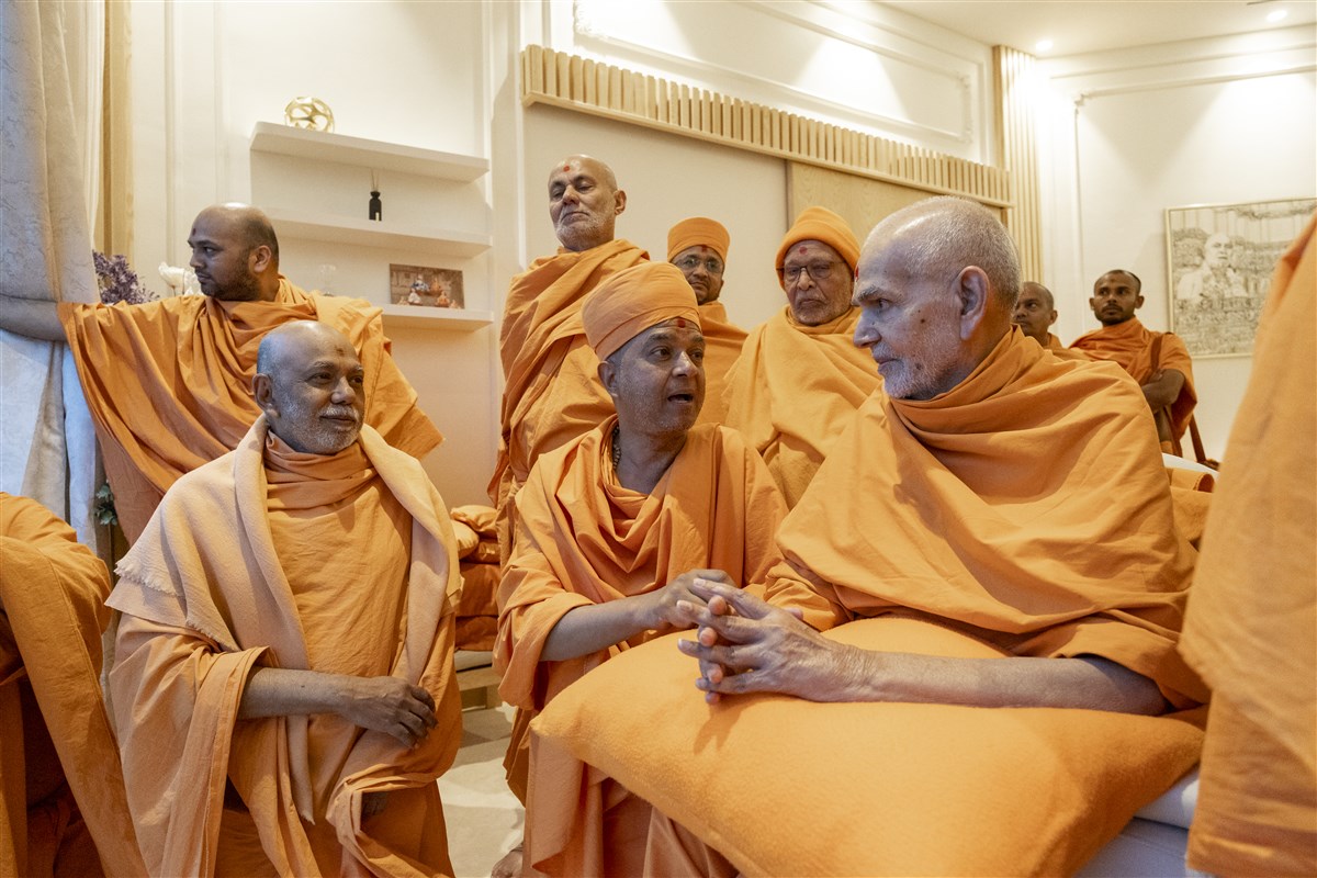 Swamishri listens attentively to Brahmaviharidas Swami as he explains some of the details of the new mandir