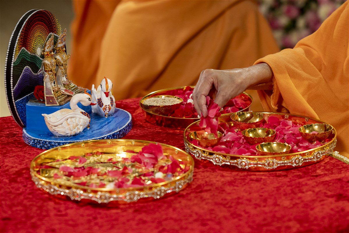 Swamishri blesses the yantras with flower petals