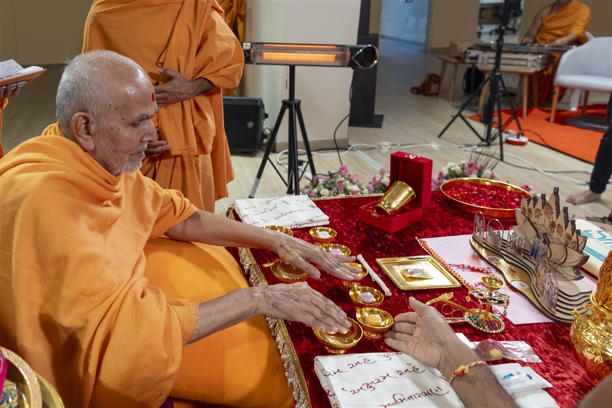 Swamishri blesses the various sacred implements of the yagna