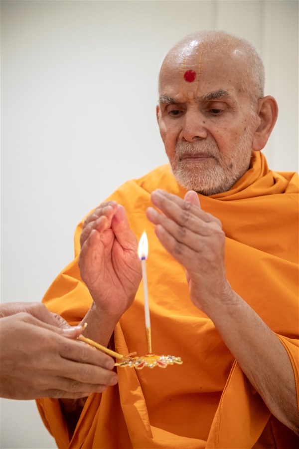 Swamishri accepts blessings from the arti