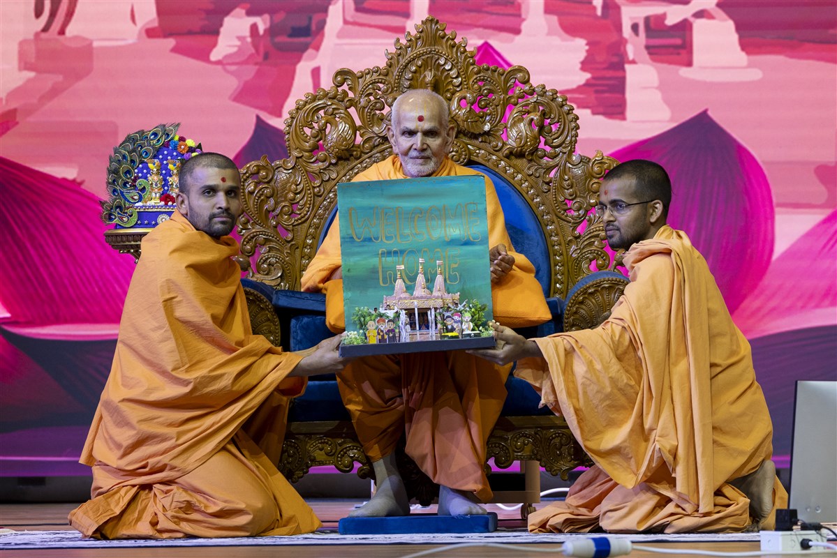 Swamis present a decorative model of the Mandir depicting harmony