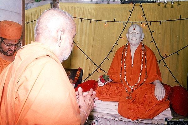 Swamishri engaged in darshan of Shastriji Maharaj at the birthplace, Mahelav