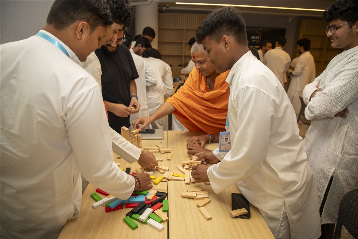 Youths participate in a team building activity with the youth.