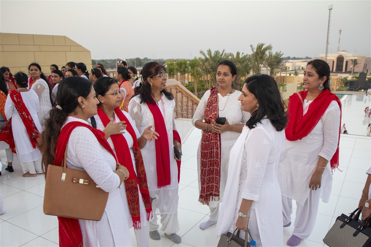 Volunteers providing a special guided tour of the mandir to shibir participants