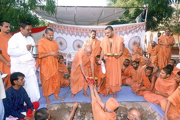 Swamishri performs the foundation-stone laying rituals for the new assembly hall