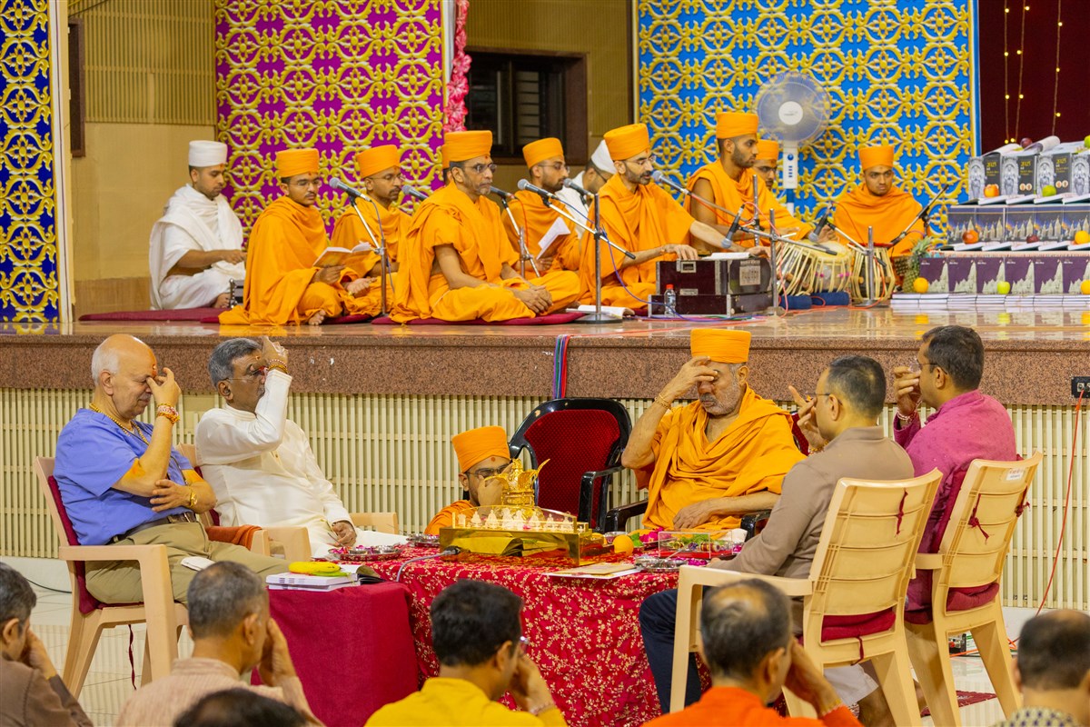 Swamis and devotees participate in mahapuja rituals