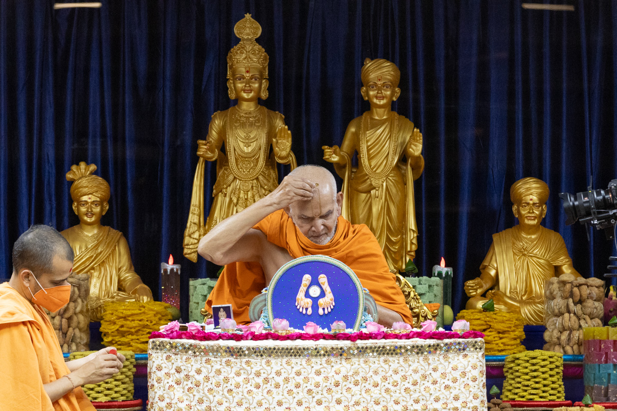 Swamishri applies a tilak on his forehead