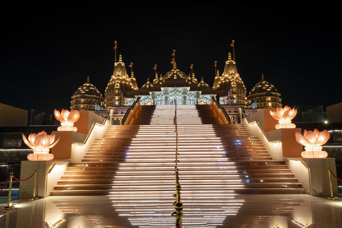 BAPS Hindu Mandir lit like a glowing lotus in the desert