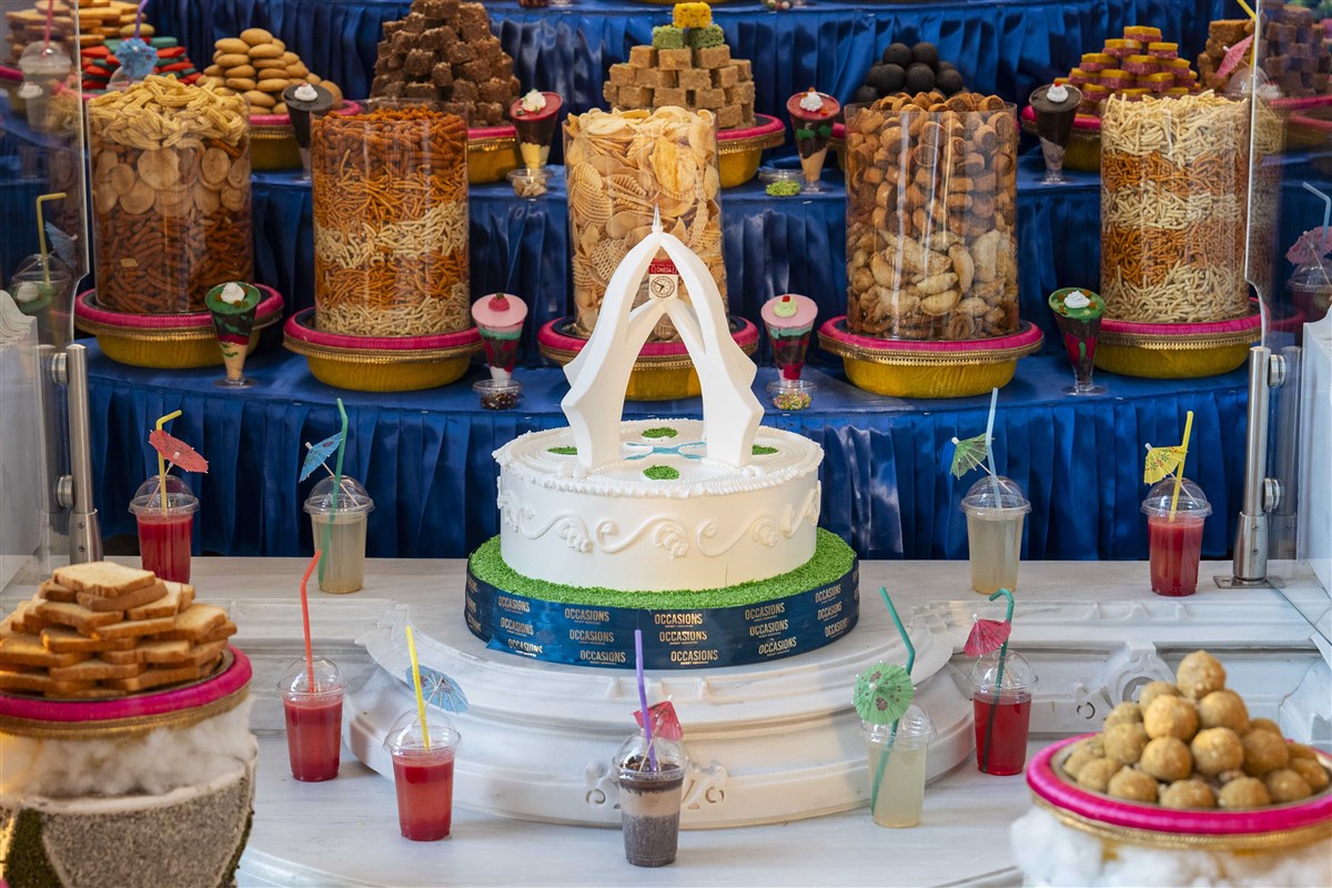 Sanctified food offered to the deities with cake marking the iconic Deira Clock Tower of Dubai
