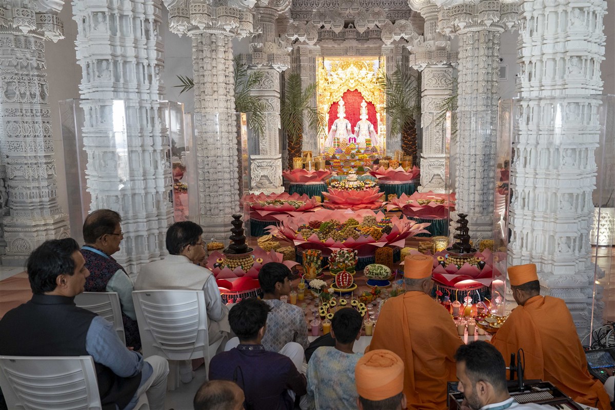 Swamis and devotees of BAPS Hindu Mandir sing prayers marking the commencement of Hindu New Year