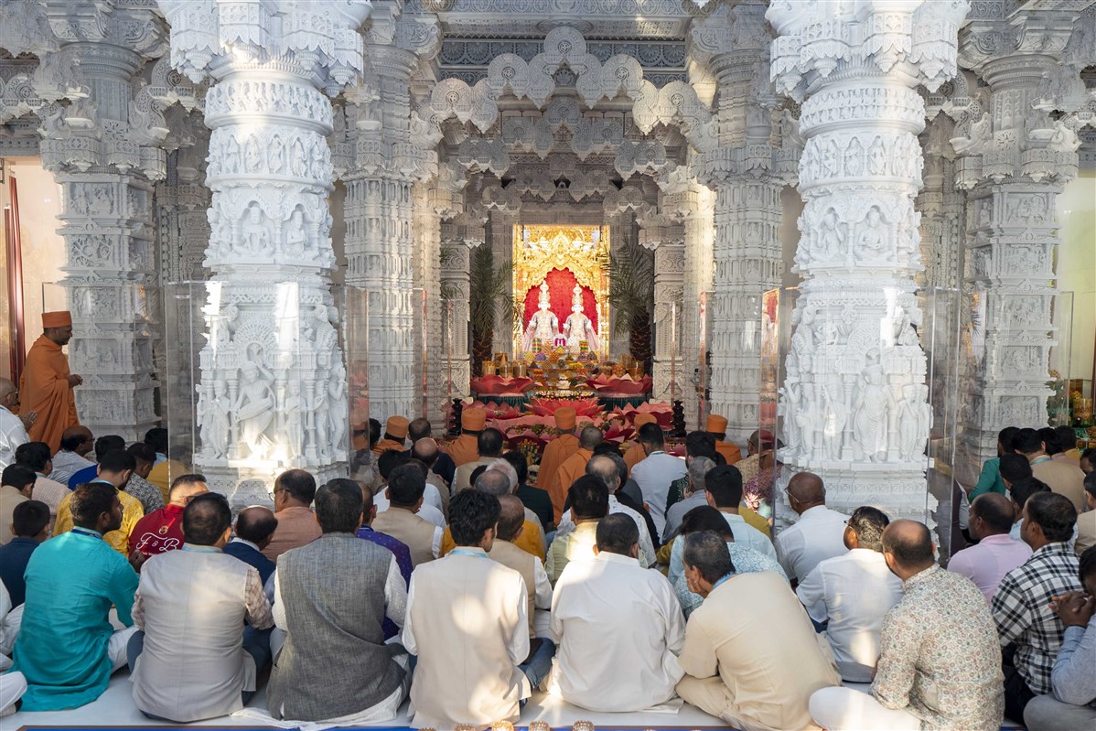 Swamis and devotees of BAPS Hindu Mandir sing prayers marking the commencement of Hindu New Year 