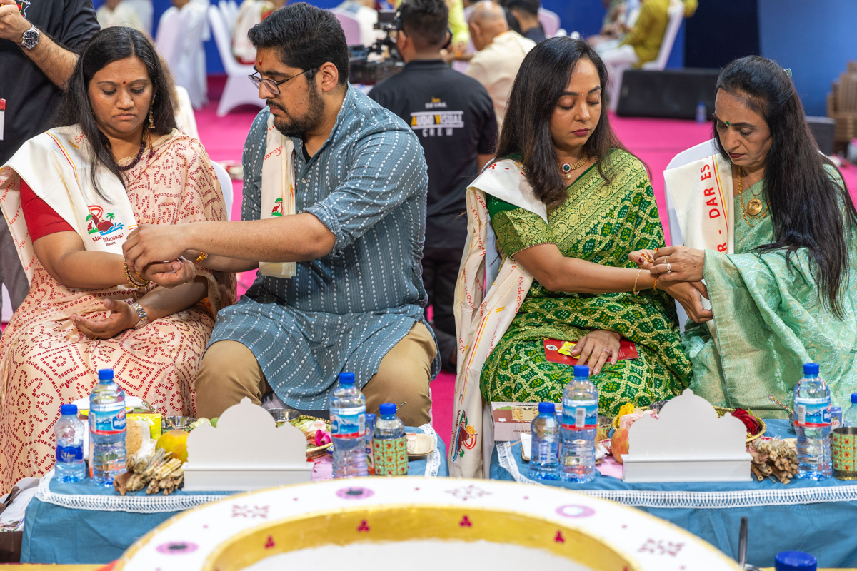 Devotees participate in the yagna rituals