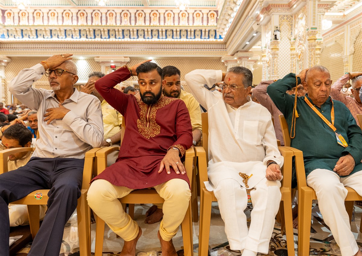 Devotees participate in pratishtha mahapuja rituals