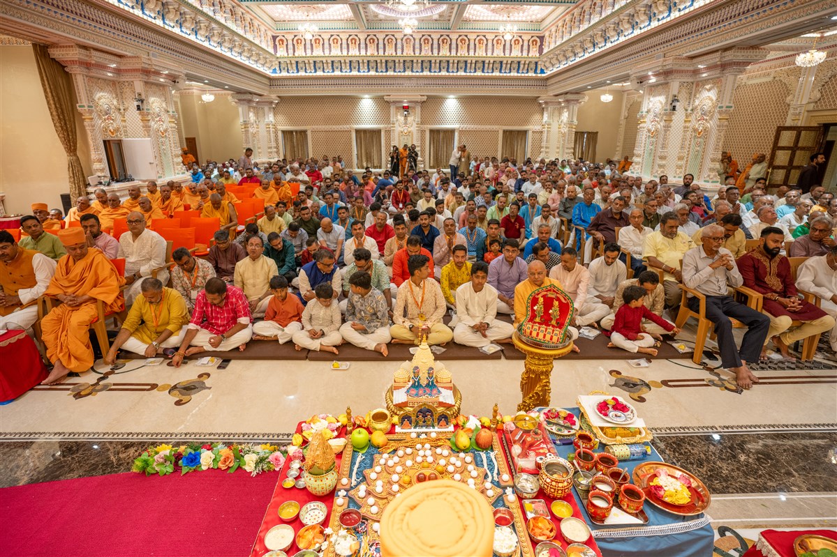 Devotees participate in pratishtha mahapuja rituals