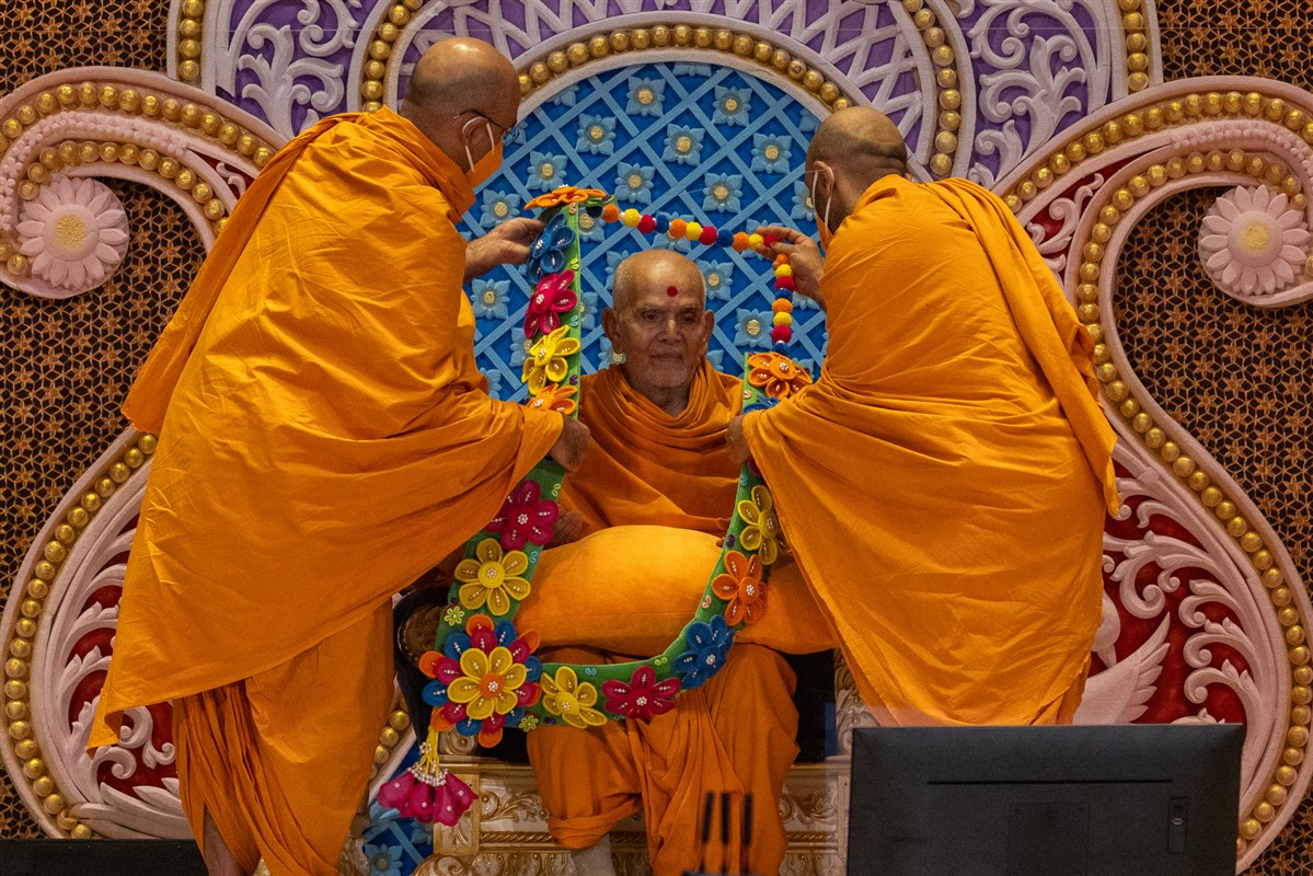 Swamis honor Swamishri with a garland