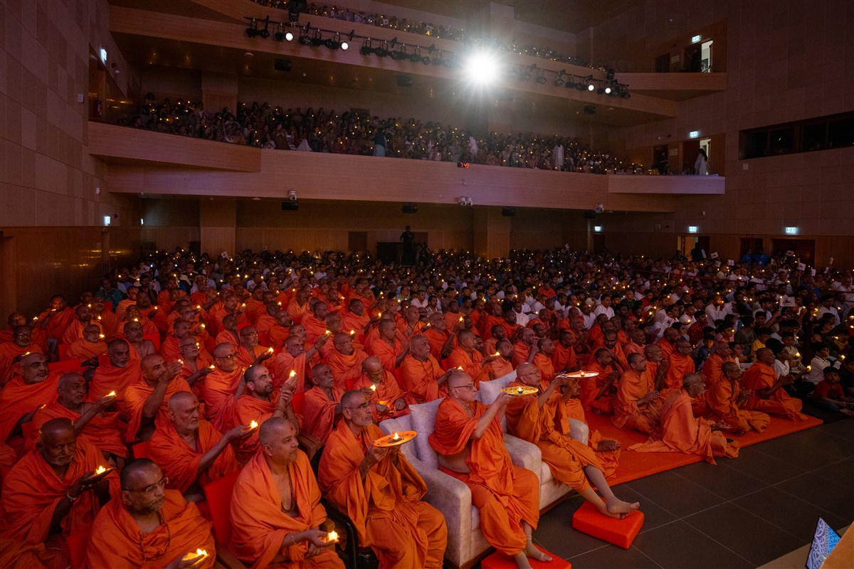 Senior swamis, swamis and devotees perform the arti