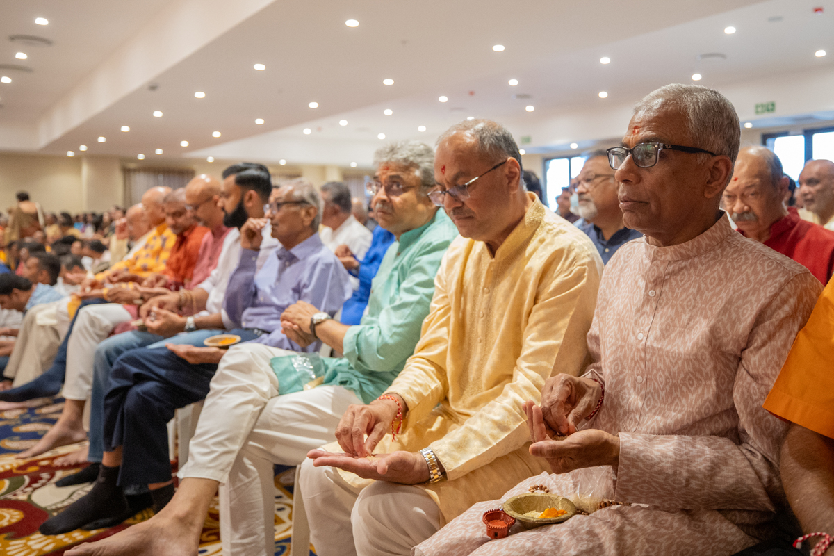Devotees participate in the pratishtha mahapuja rituals