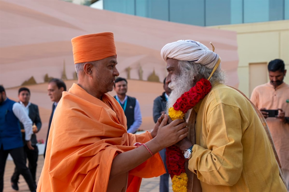 Swami Brahmaviharidas welcomes Sadhguru with a sacred garland