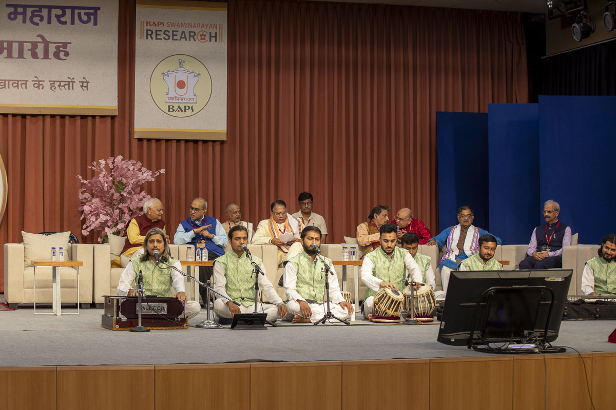Youths sing kirtans at the beginning of the book launch assembly