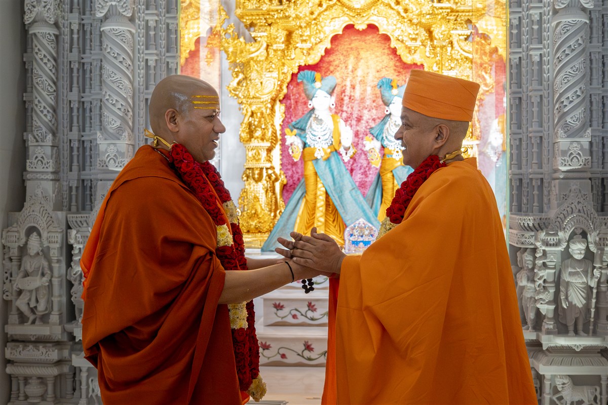 The two sadhus share a moment of heartfelt appreciation and gratitude
