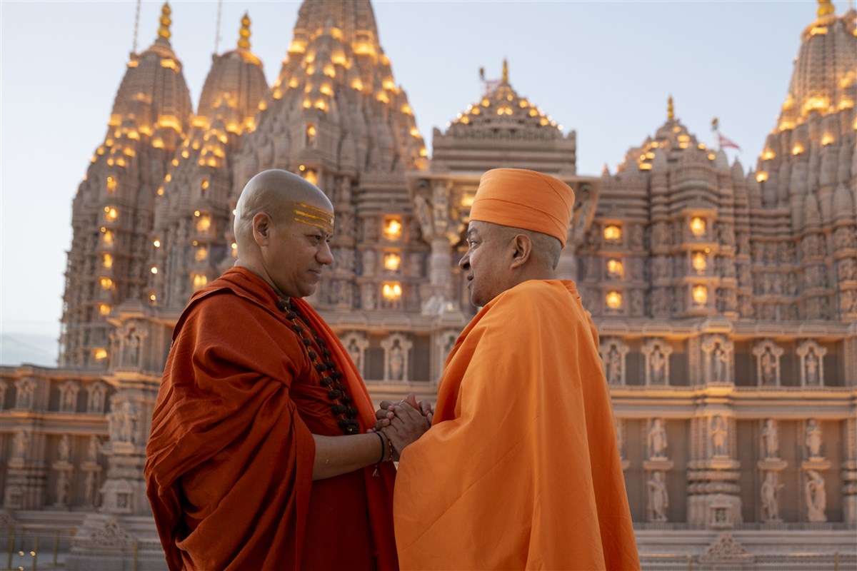 After the Aarti, the two sadhus share a heartfelt moment of appreciation and unity, hand in hand