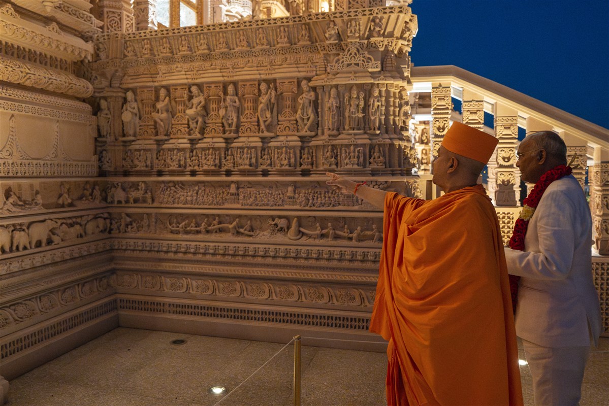 Swami Brahmaviharidas highlights stories from the Ramayan depicted through detailed stone carvings on the Mandir’s exterior façade.