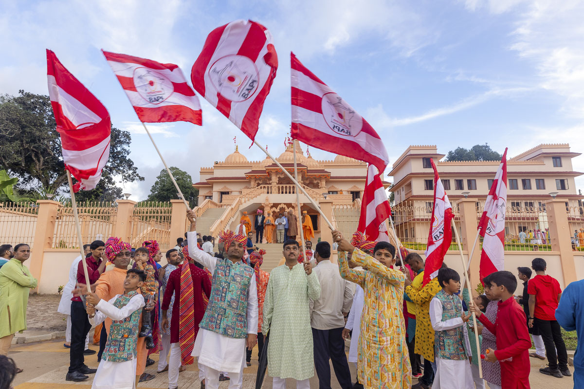 Devotees wave BAPS flags