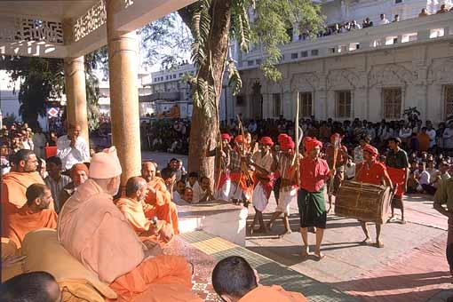 The tribal devotees then present a traditional dance before Swamishri