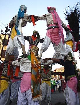 Exciting human pyramids during the procession by youth dancers, sadhus and tribal youths 