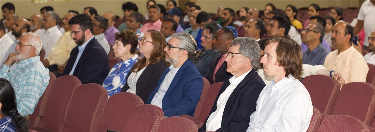 Attendees from diverse faiths and backgrounds gather in solidarity during the prayer assembly.