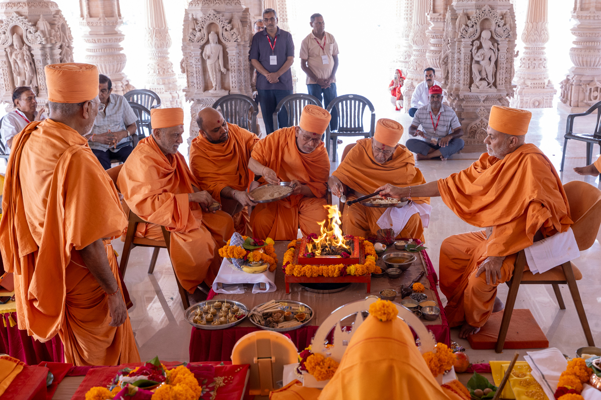 Senior swamis perform the vastu pujan rituals