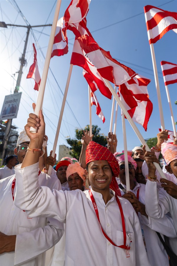 Youths wave BAPS flags