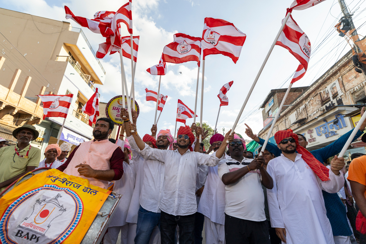 Youths wave BAPS flags