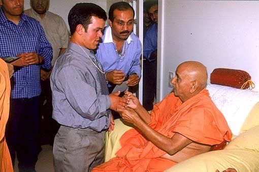 Swamshri meeting Bernadino, once a deaf and dumb boy is now normal through Swamishri's blessings