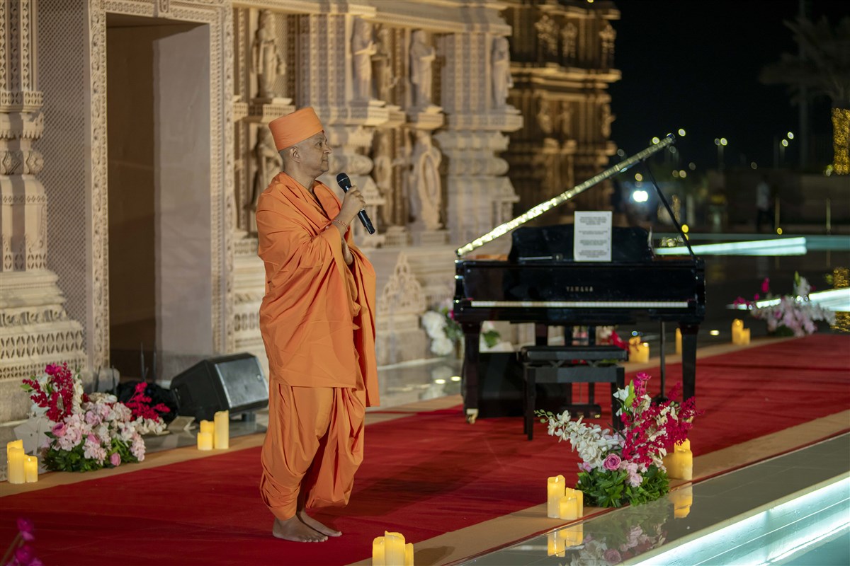 As the audience pauses to reflect, Swami Brahmaviharidas, the visionary behind the event, is invited to share his thoughts about the evening.