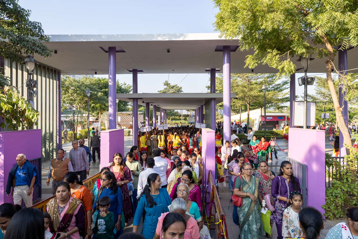 Devotees arrive in the celebration assembly