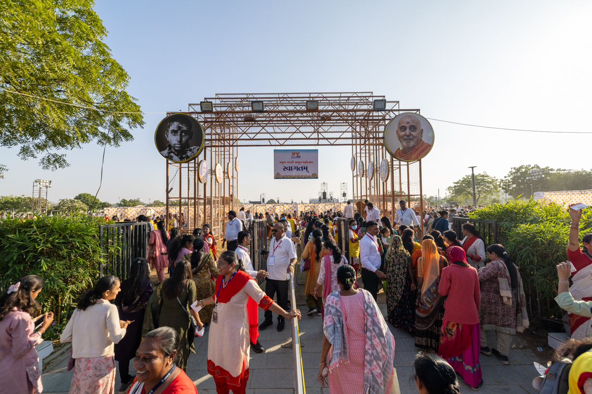 Devotees arrive in the celebration assembly