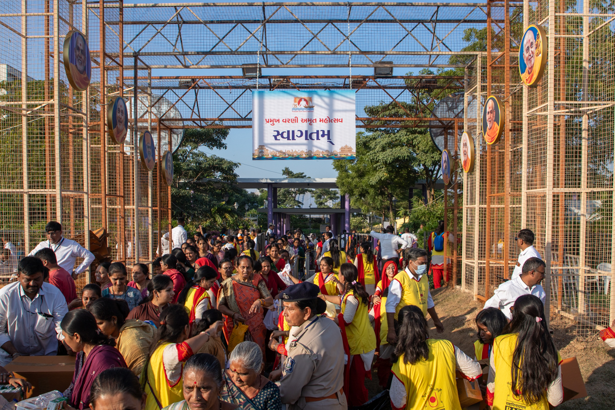 Devotees arrive in the celebration assembly