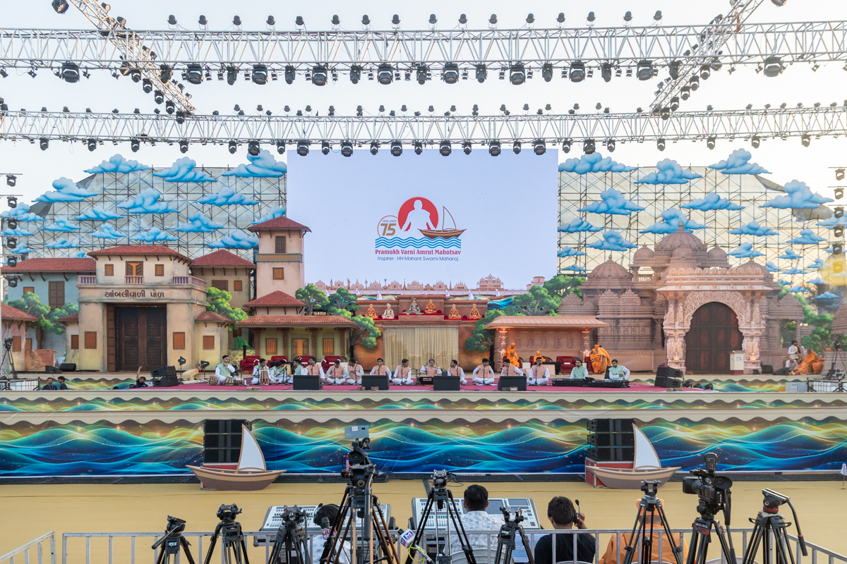 Youths sing kirtans at the beginning of the Pramukh Varni Amrut Mahotsav celebration assembly